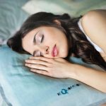 woman sleeping on blue throw pillow