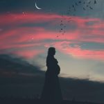 pregnant woman under cloudy sky in silhouette photography