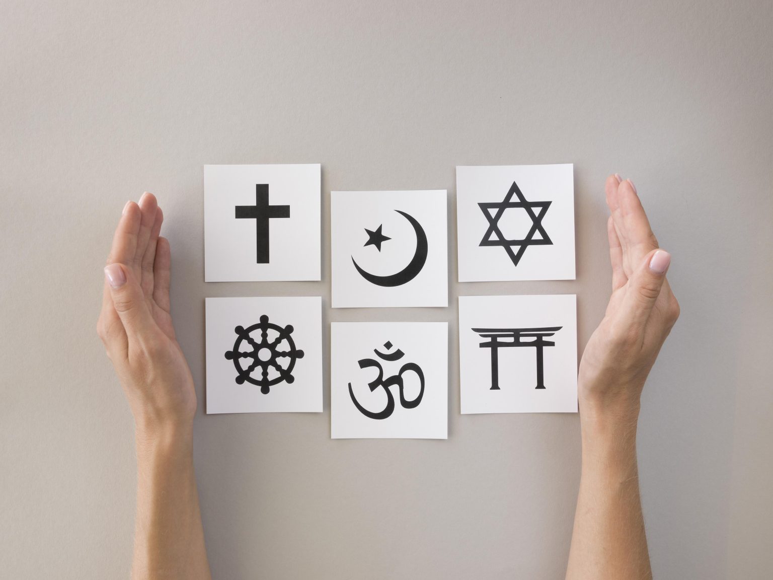 flat lay assortment religious symbols ধর্মবাজ বনাম মুক্তবাজ: জাত পাত যার যার; আত্মদর্শন সবার পর্ব-২