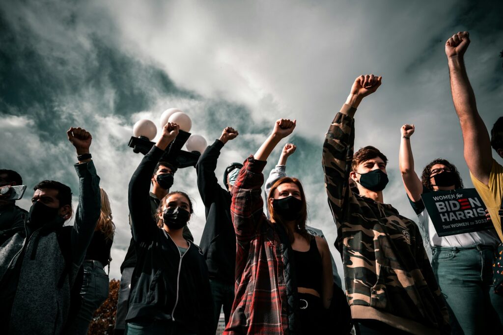 group of people raising their hands গণতন্ত্র বনাম একনায়কতন্ত্র: বাংলাদেশ কি বদলাচ্ছে?